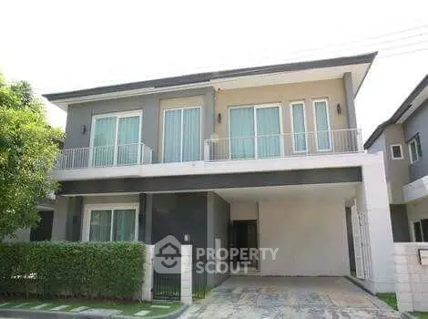 Modern two-story house with sleek design and spacious driveway