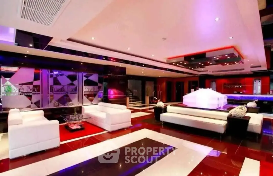 Luxurious modern lounge with sleek design and vibrant lighting, perfect for entertaining guests.