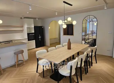 Spacious modern dining area with elegant lighting and stylish decor