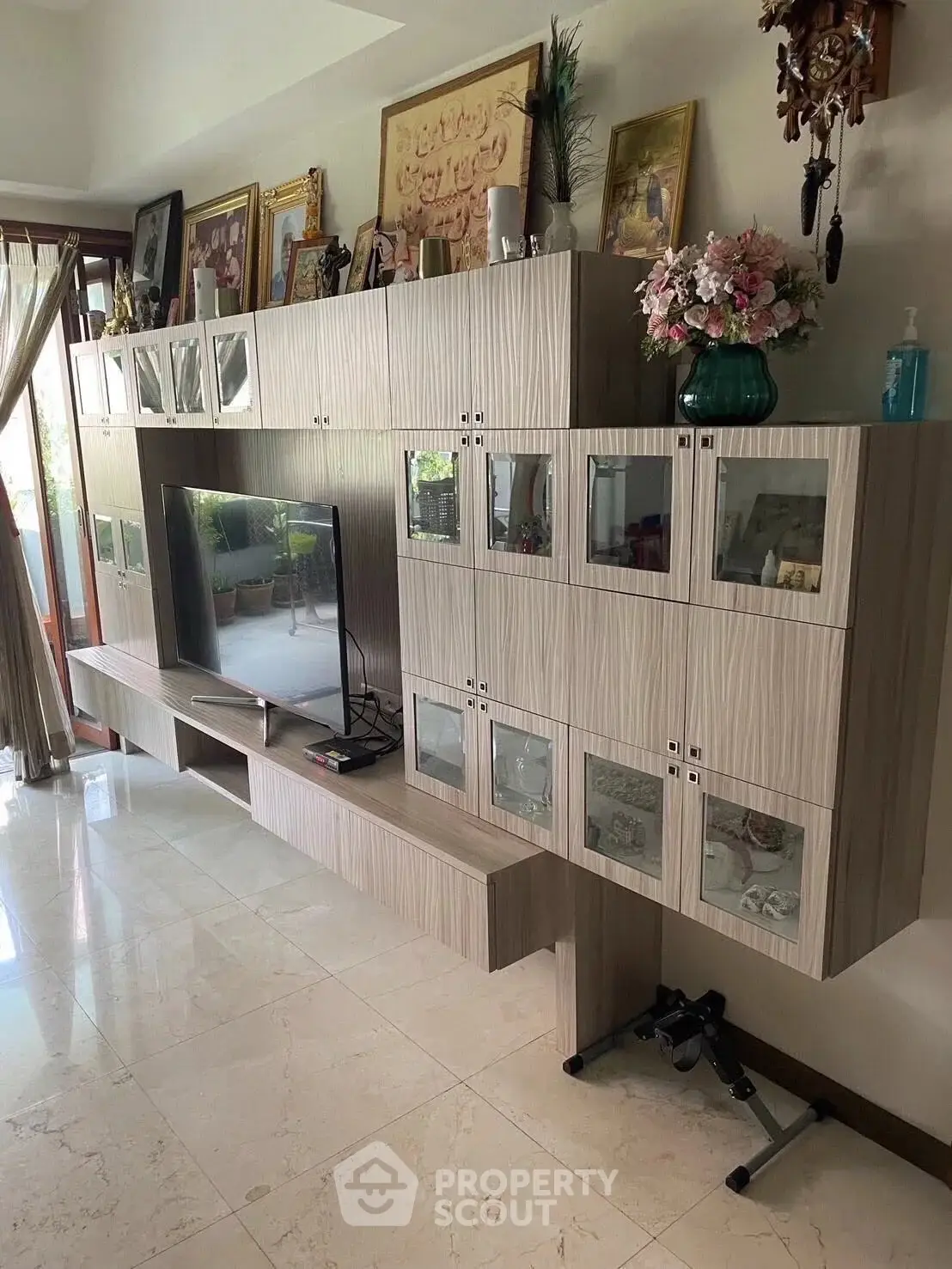 Elegant living room with modern entertainment center and decorative accents