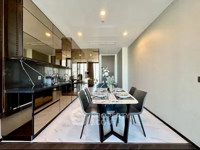 Luxurious modern dining area with sleek kitchen and elegant decor