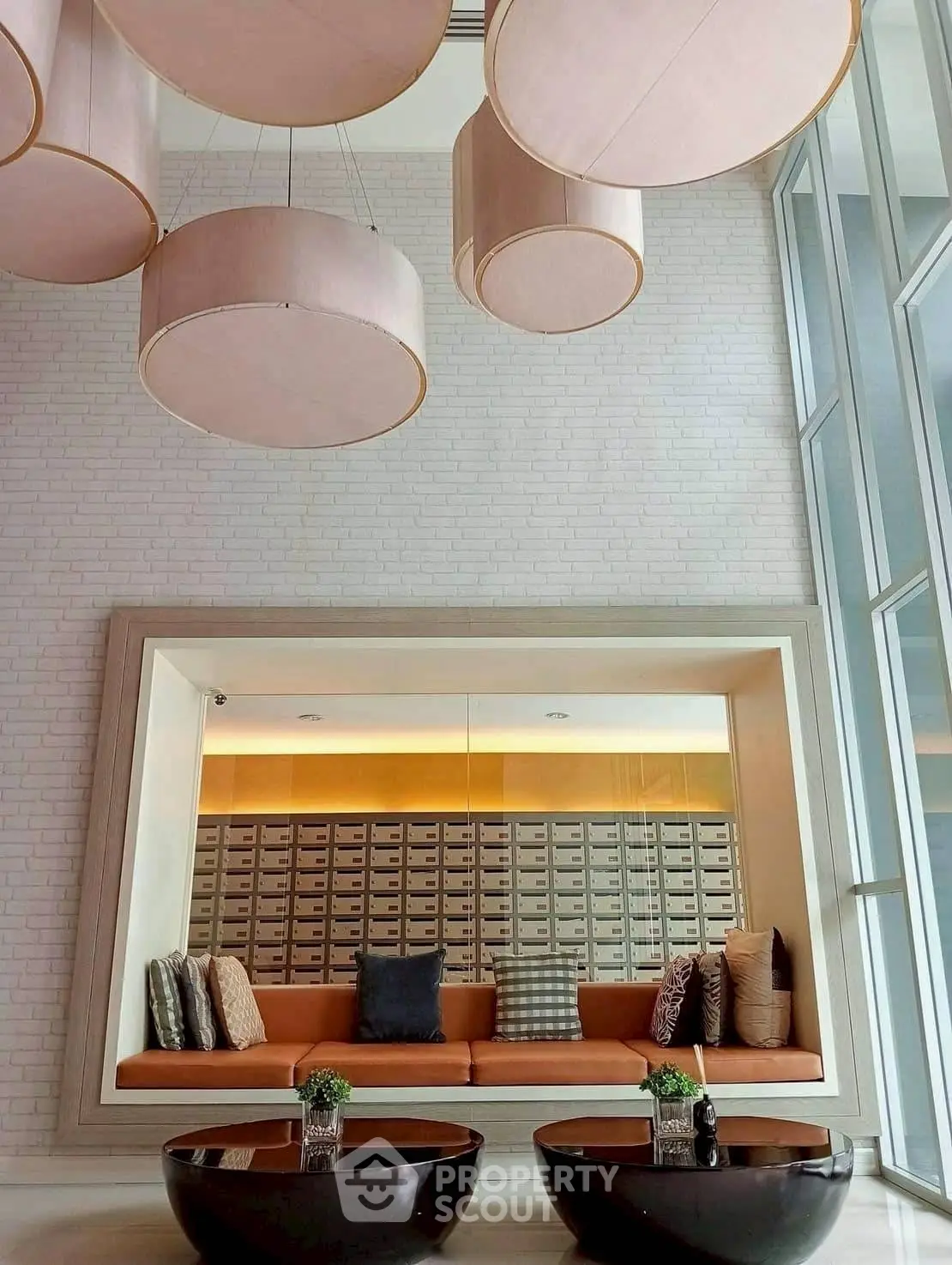 Modern lobby with stylish seating and unique ceiling design in luxury building.