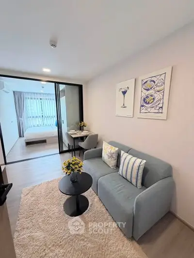 Modern living room with cozy sofa and stylish decor in open-plan apartment