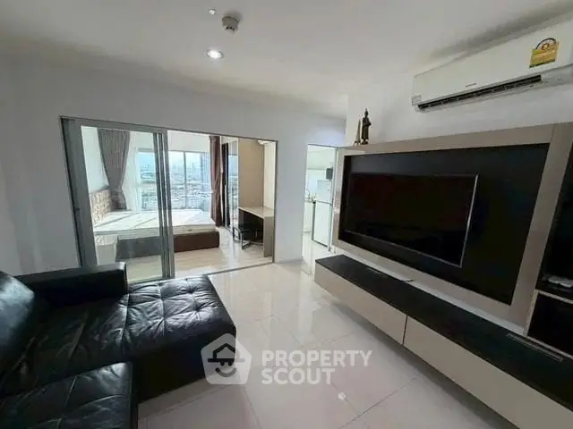 Modern living room with sleek furniture and city view in a stylish apartment.