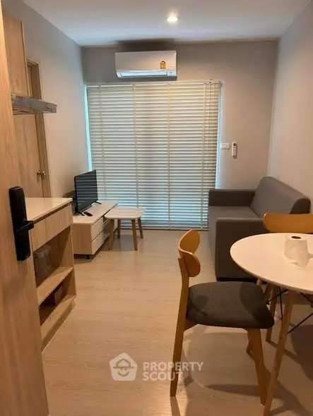 Cozy living room with modern furniture and natural light, perfect for relaxation and entertainment.