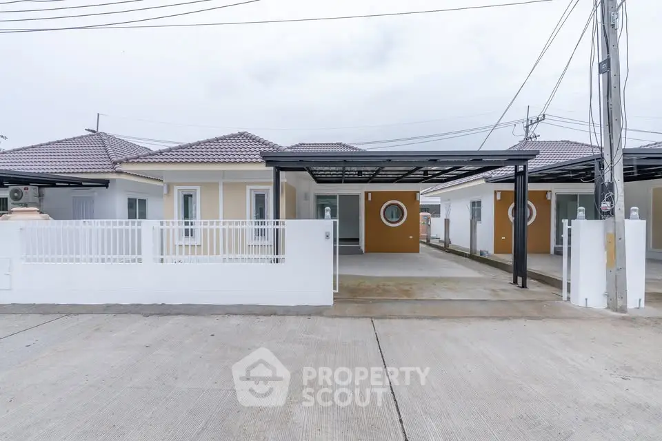 Modern single-story house with carport and circular window design