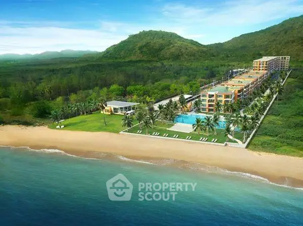 Luxurious beachfront resort with pool and lush greenery, offering stunning ocean views and serene surroundings.