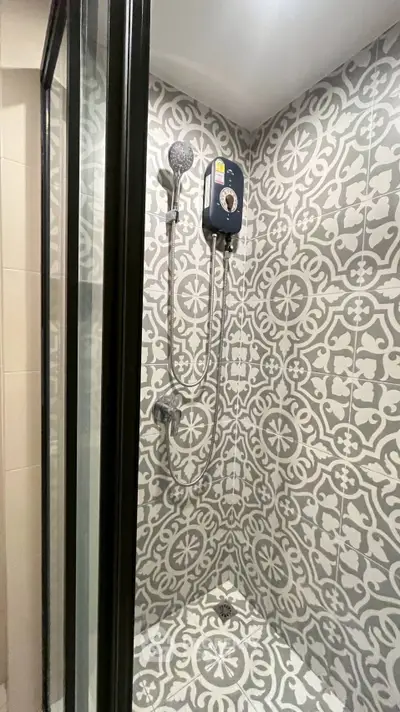 Stylish bathroom shower with patterned tiles and modern fixtures