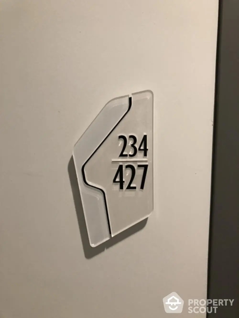 Modern apartment door number sign with sleek design