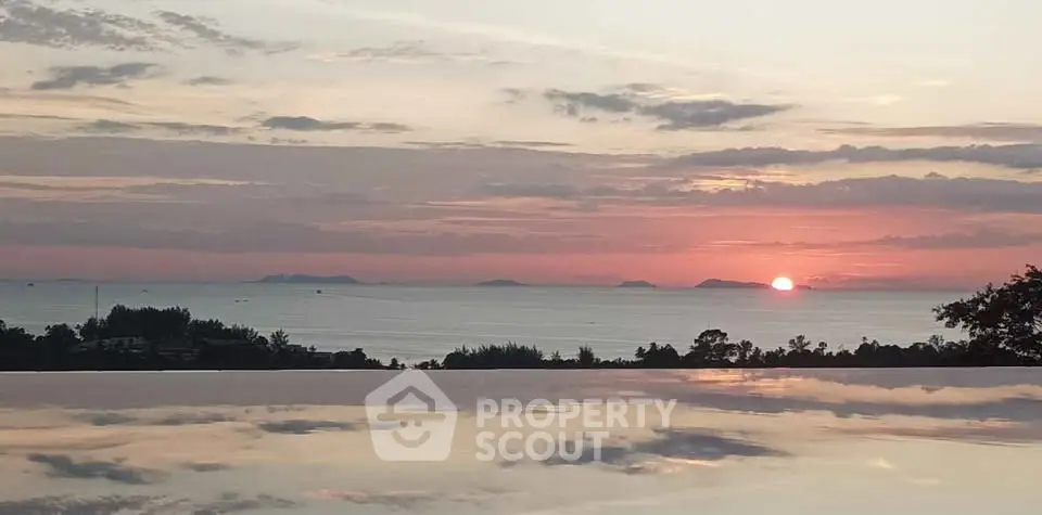 Stunning sunset view over infinity pool with ocean horizon