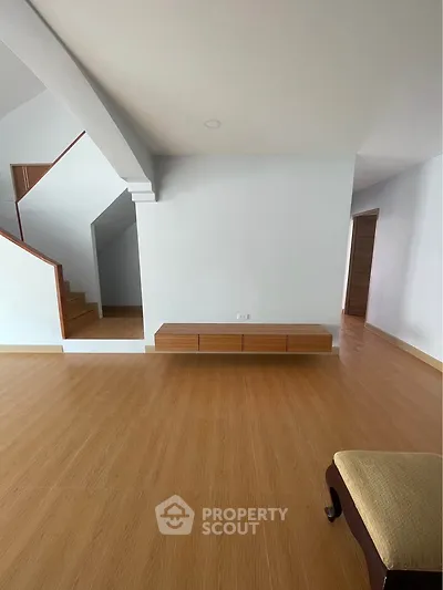Spacious modern living room with wooden flooring and minimalist design
