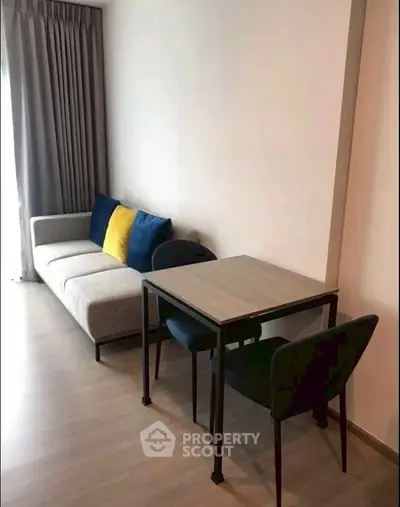 Modern living room with stylish sofa and dining table, perfect for cozy urban living.