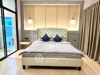 Luxurious bedroom with elegant decor and plush bedding in modern apartment.