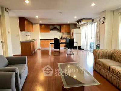 Spacious open-plan living room with modern kitchen and stylish furniture