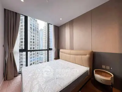 Modern bedroom with large window offering stunning city views in a high-rise apartment.