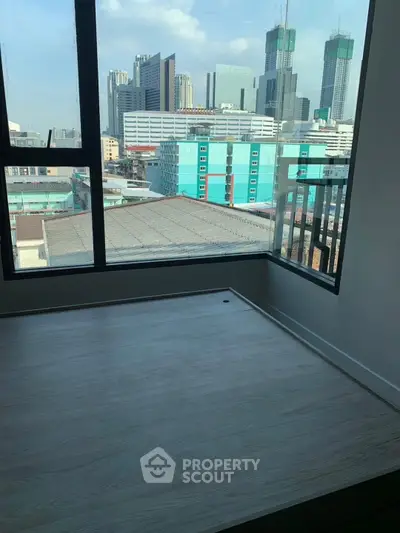 Modern apartment with stunning city view and large windows, perfect for urban living.