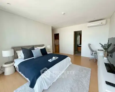 Spacious modern bedroom with stylish decor and natural light