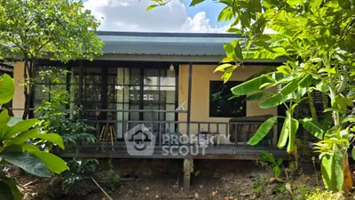 Charming single-story home with lush garden and cozy porch, perfect for nature lovers.