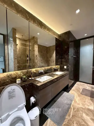 Luxurious modern bathroom with marble finishes and dual sinks