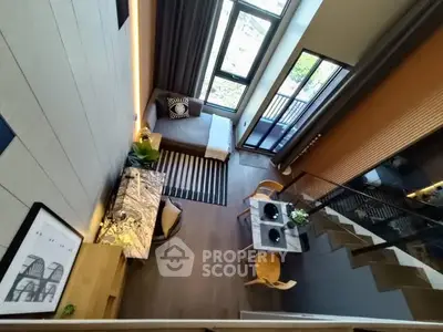 Stunning modern loft with high ceilings and large windows offering abundant natural light and stylish decor.