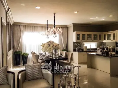 Luxurious open-layout kitchen and dining area with elegant chandelier and stylish decor.