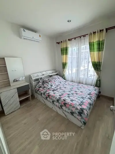 Bright and cozy bedroom with modern decor and large windows for natural light.