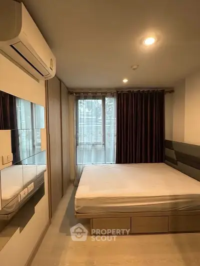 Modern bedroom with large window and air conditioning in stylish apartment