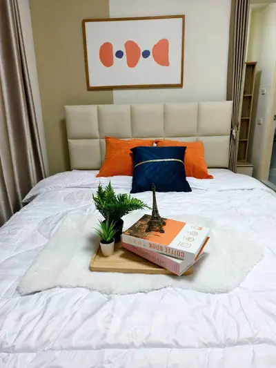 Cozy bedroom with modern decor and plush bedding, perfect for relaxation.
