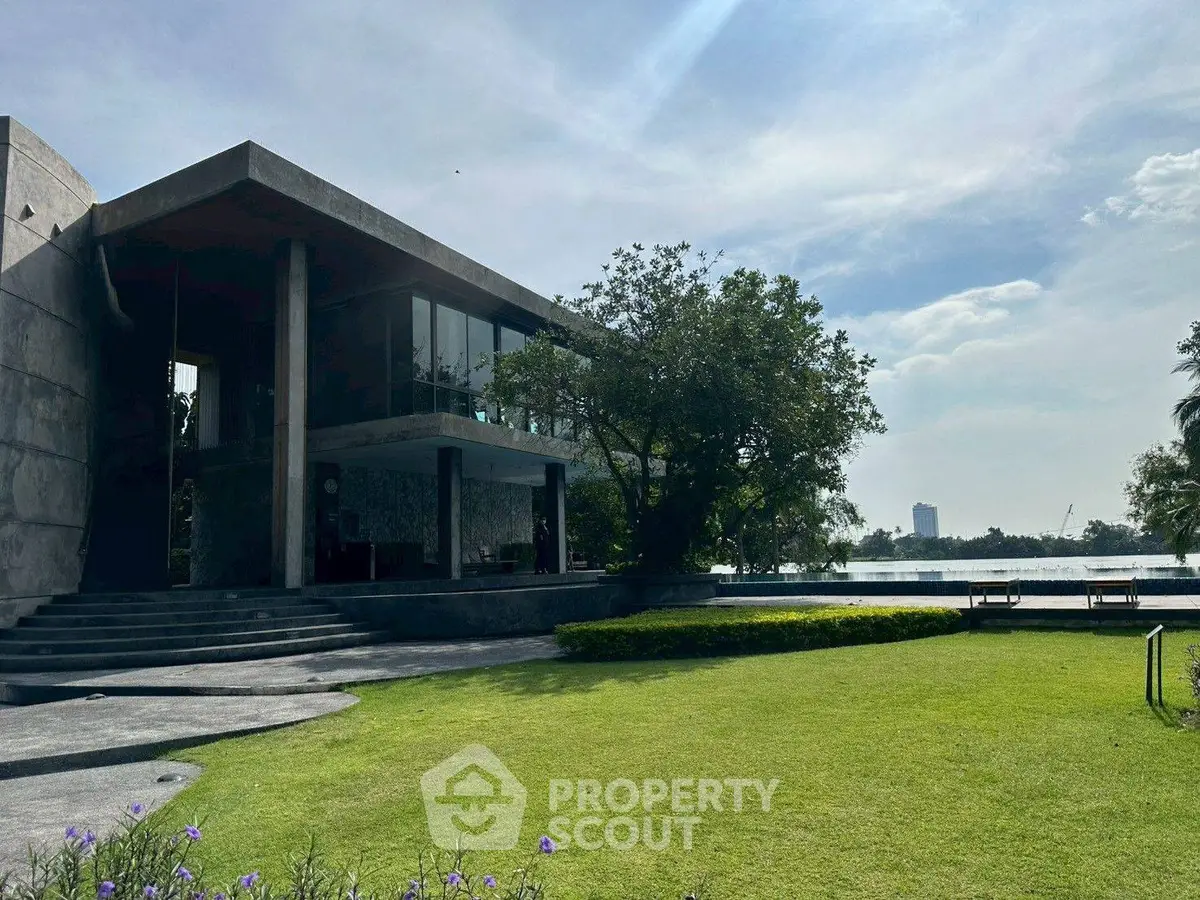 Modern architectural masterpiece with lush garden and serene water view