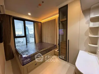 Modern bedroom with city view, featuring large windows and sleek built-in storage solutions.