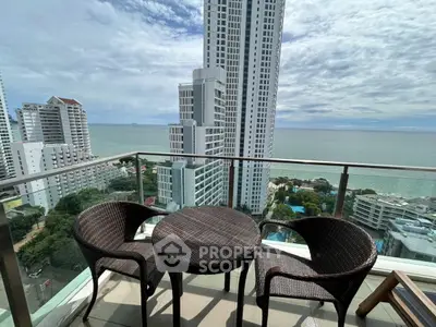 Stunning ocean view from high-rise balcony with modern seating