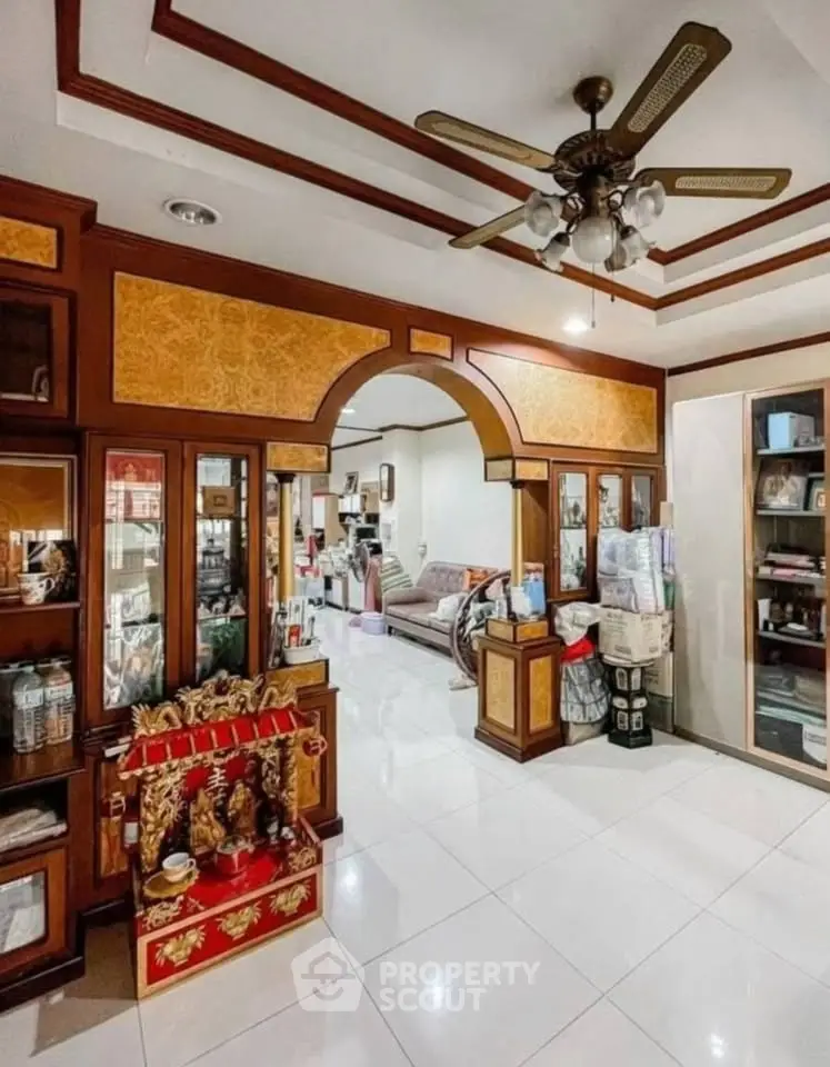 Spacious living room with elegant wooden decor and ceiling fan