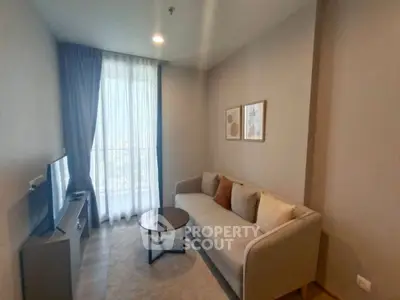 Cozy living room with modern sofa and TV, perfect for relaxation.