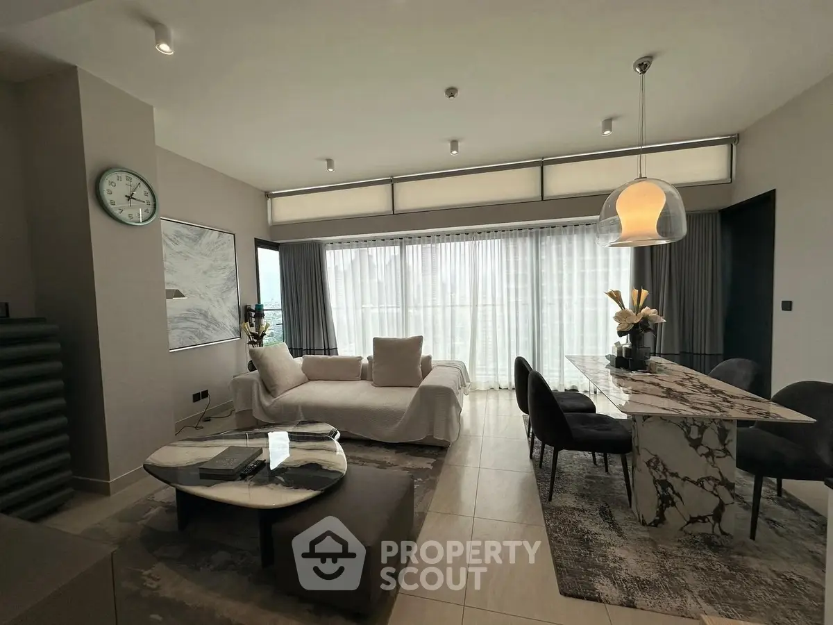 Luxurious modern living room with elegant marble dining table and cozy seating area.