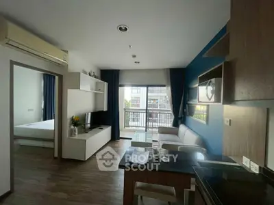 Modern living room with open kitchen and balcony view in stylish apartment