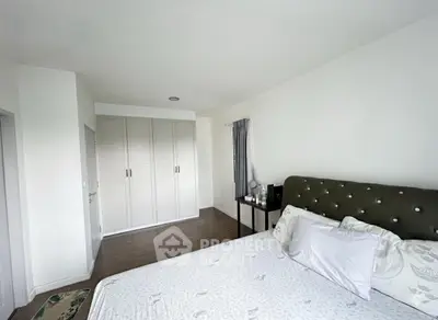 Spacious bedroom with elegant decor and ample storage space