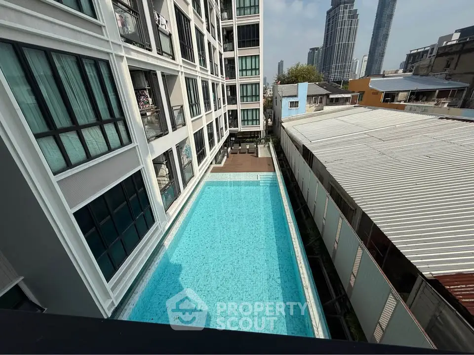 Modern apartment building with rooftop pool and city view