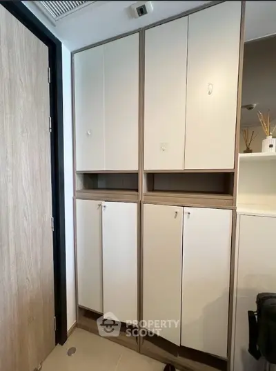 Modern storage cabinets in a sleek interior space with wooden accents and minimalist design.