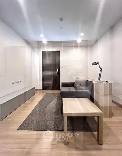 Modern living room with sleek furniture and wooden flooring, perfect for cozy gatherings.