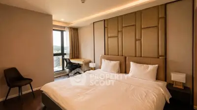 Luxurious bedroom with modern decor and large window offering stunning views.