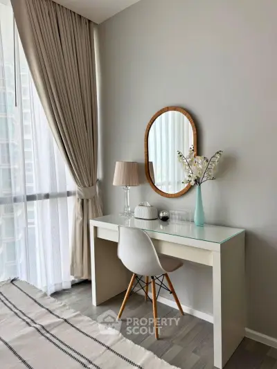Stylish study nook with modern desk, chair, and elegant decor in a bright apartment.