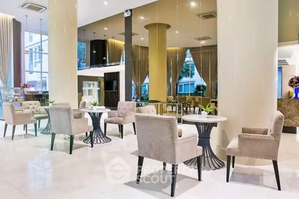 Luxurious modern lobby with elegant seating and floor-to-ceiling windows in a high-end building.