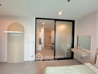 Modern bedroom with sliding glass door and minimalist decor