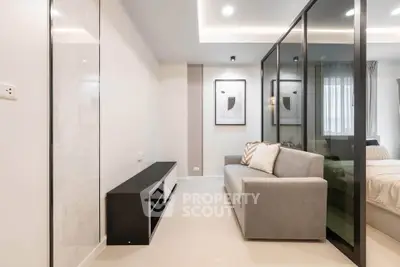 Modern living room with sleek design and glass partition