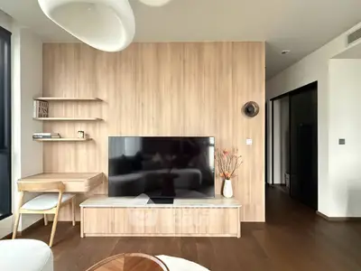 Modern living room with wooden accents and sleek TV setup