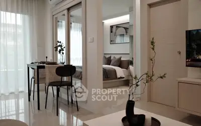 Modern open-plan living room with dining area and view into cozy bedroom
