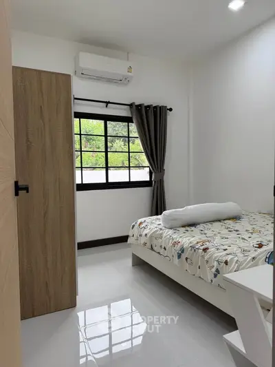 Cozy bedroom with modern decor and large window view