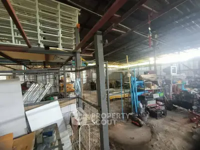 Spacious industrial storage area with metal shelving and equipment