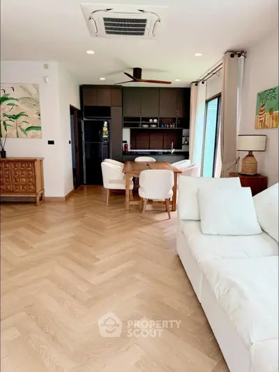 Modern open-plan living room with stylish decor and natural light