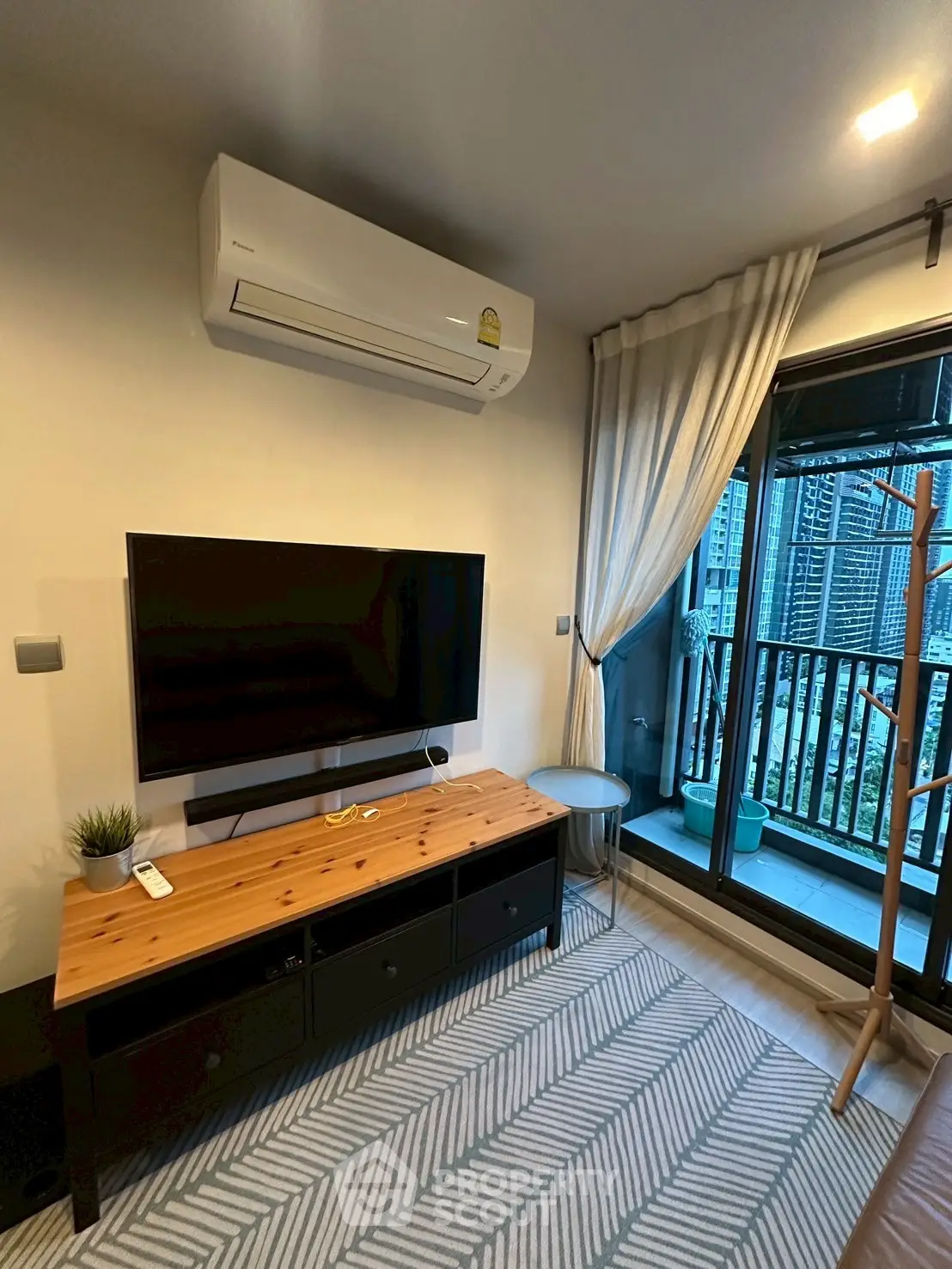 Modern living room with balcony view, air conditioning, and stylish decor